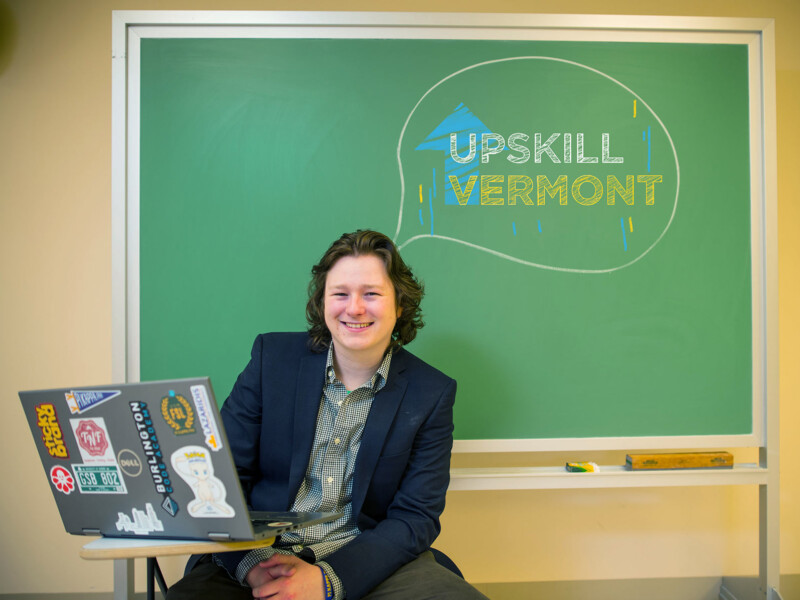 Upskill Vermont student sitting at a desk with a laptop